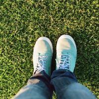 Feet on healthy green grass