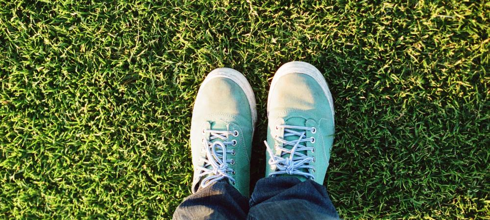 Feet on healthy green grass